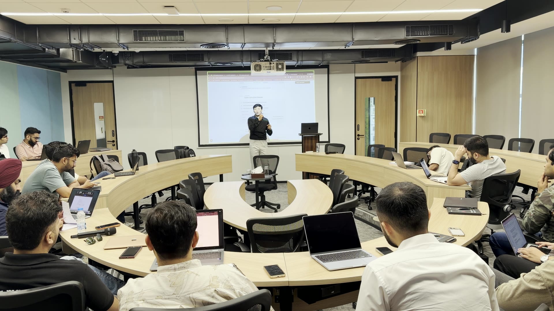 Darshan Rathod teaching a classroom of traders